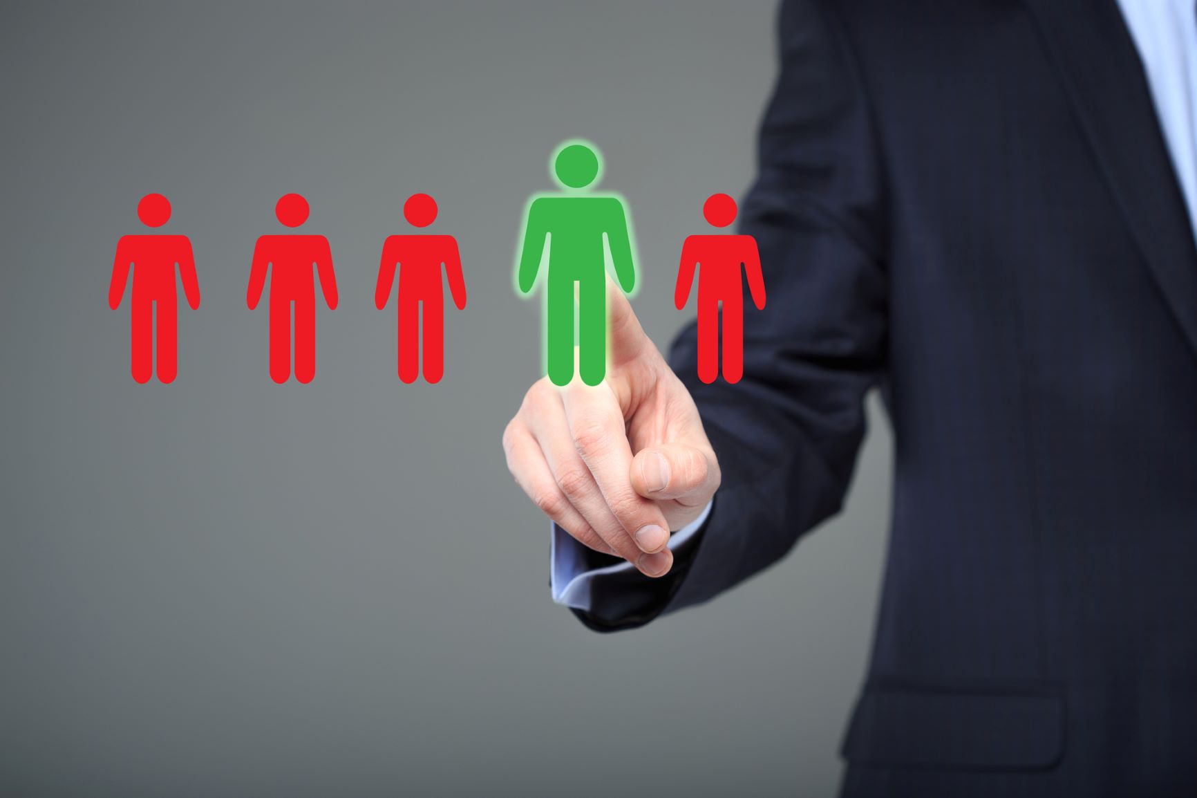 A row of five animated human icons, four the same size and colored red, while one is being indicated by a person in a business suit, and appears larger and colored green.